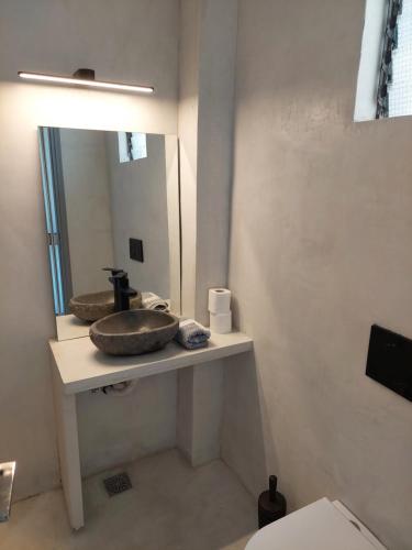 a bathroom with a sink and a mirror at Golden Star Praxitelous in Agia Marina Aegina