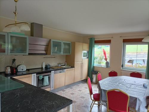 a kitchen with a table and chairs and a dining room at Willa Sielanka in Karpacz