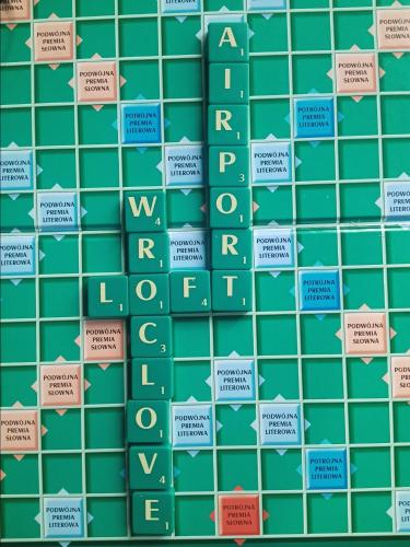 a pattern of green tiles with the words wealth at Wroclove Airport Loft in Wrocław