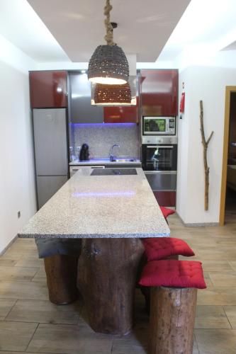 a kitchen with a table made out of logs at Recanto do Sol in Vieira do Minho