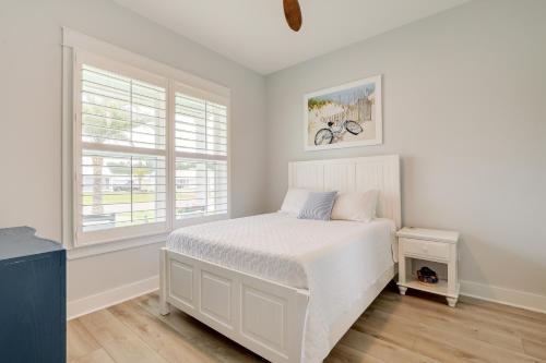 a white bedroom with a bed and two windows at Bright Foley Home with Patio - 7 Mi to Wharf and Beach in Foley
