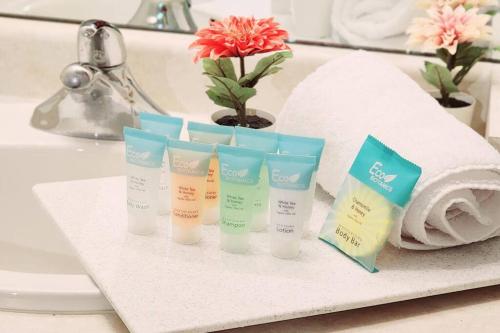 a group of four bottles of sunscreen on a bathroom sink at Lakeview Condo in Downtown with Free Parking. in Toronto