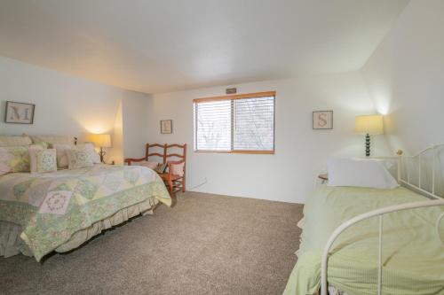 a bedroom with two beds and a window at The Love Shack - Cozy cabin in a such a great spot! Very quiet neighborhood in Sugarloaf