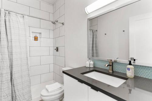 a bathroom with a sink and a toilet and a mirror at Scottsdale OT Classic BoHo Micro Studio in Scottsdale