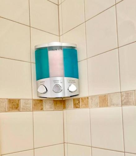 a toaster on a tiled wall in a bathroom at Private Rooms close to Miami Airport - Free parking - 02 in Miami