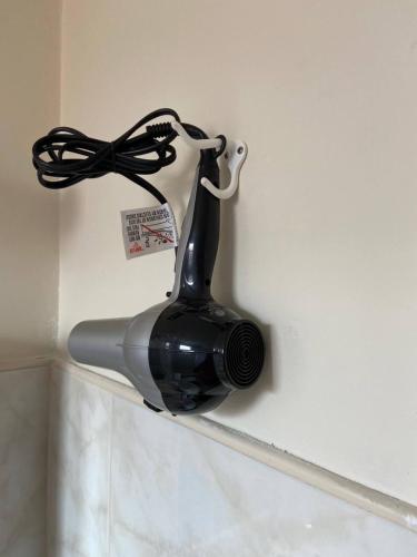 a camera hanging on a wall with a ribbon at Private Rooms close to Miami Airport - Free parking - 02 in Miami