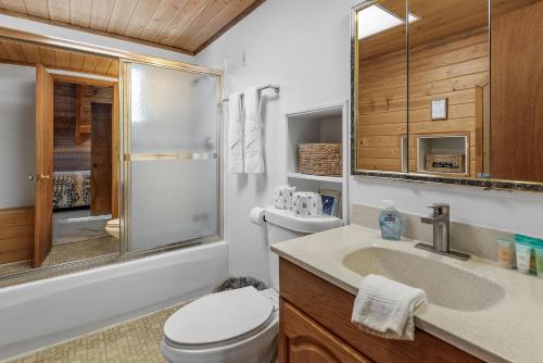 a bathroom with a toilet and a sink and a shower at The Lakehouse Cabin - Located close to the Lake! Hot Tub, Smart TV, and WiFi! in Big Bear Lake