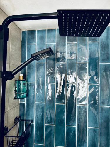a room with a blue tiled wall at Hotel No5, Beachfront with Free Private Car Park in Llandudno