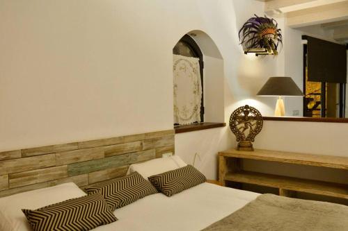 a bedroom with two beds and a table and a mirror at Can Senio 3 in Tossa de Mar