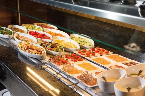 a buffet line with many different types of food at Riu Santa Fe - All Inclusive in Cabo San Lucas