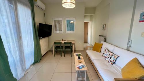 a living room with a couch and a table at 100 meters from the sea in Xylokastron