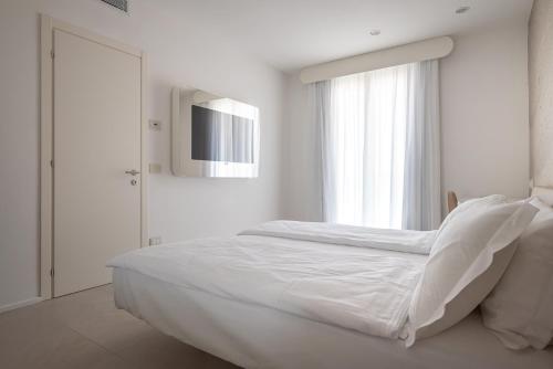 Unico Hotel Caorleにあるベッド