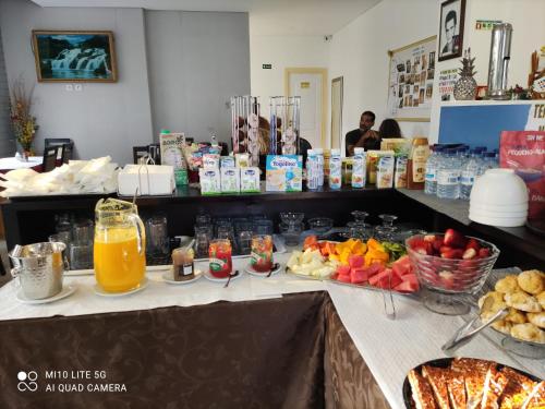a counter with a bunch of food and drinks on it at Palacio Nova Seara 2503 - AL in Armamar