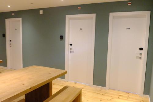 two doors in a room with green walls at Liberator Rossio in Lisbon