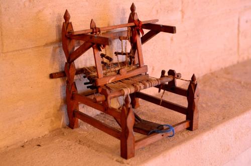 a wooden sewing machine hanging on a wall at Casa Contini in Matera