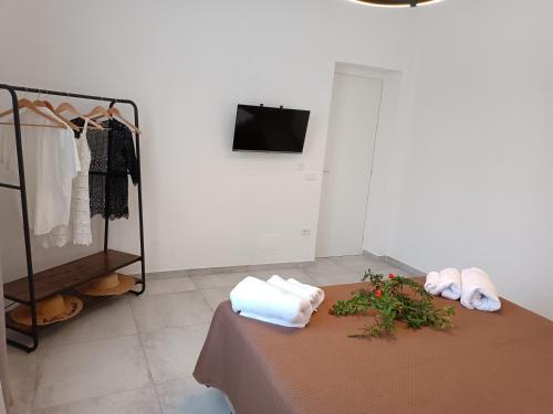Clio's House - Mondello في مونديلّو: غرفة مع طاولة مع المناشف وخزانة ملابس