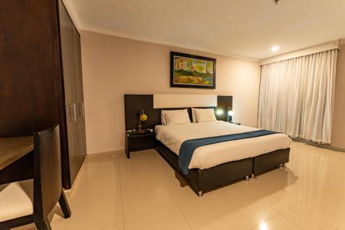 a bedroom with a large bed in a room at Hotel Miraval in Montería