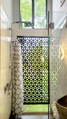a shower with a glass door in a bathroom at Rusty's Hideaway - Adorable tiny house on a beautiful farm in Moorland