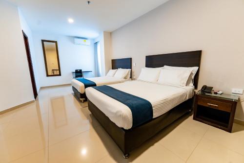 a hotel room with two beds in a room at Hotel Miraval in Montería