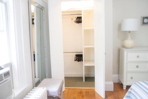 a bedroom with a mirror and a white dresser at Your Cozy and Relaxing Retreat in Woburn