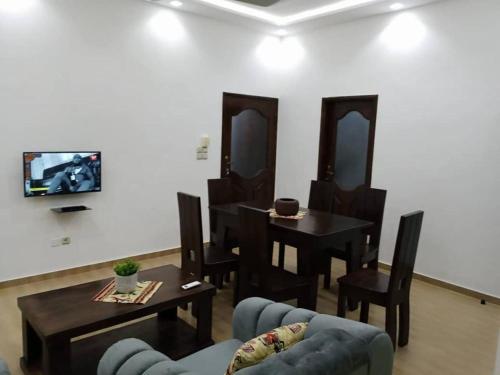 a living room with a couch and a table and chairs at Résidence des amazones Appartement 1 in Cotonou