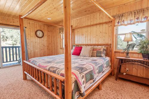 a bedroom with a bed in a wooden room at Bear family Ranch - Perfect for groups! ideal location for stargazing and sky watching! in Big Bear City