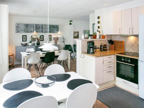 a kitchen and dining room with a table and chairs at 8 person holiday home in Bagenkop-By Traum in Bagenkop