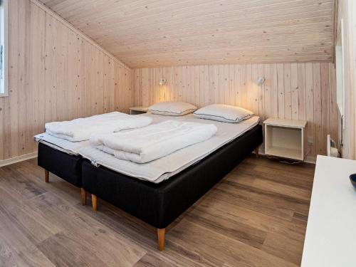 a bedroom with a large bed in a room at Holiday home Harboøre XXIII in Harboør