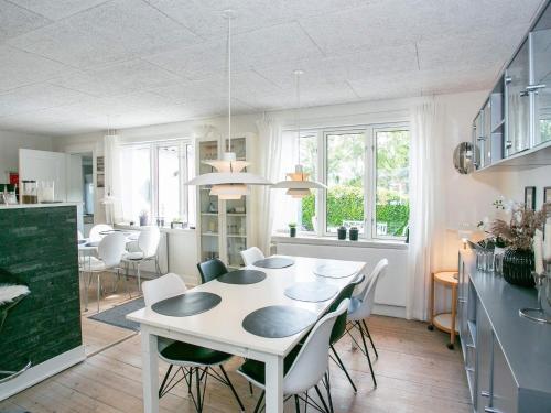 a kitchen and dining room with a white table and chairs at 8 person holiday home in Bagenkop-By Traum in Bagenkop