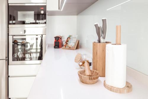 a kitchen with wooden utensils on a counter at Pilgrim Home in Fátima
