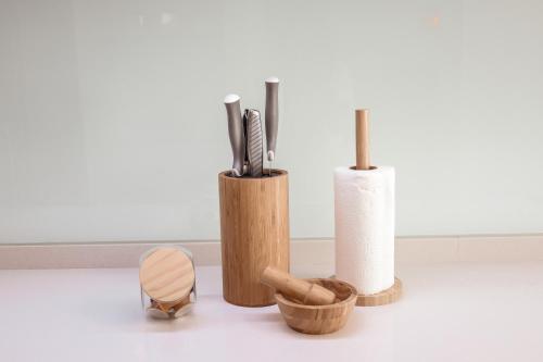 a group of three wooden vases and a roll of paper towels at Pilgrim Home in Fátima