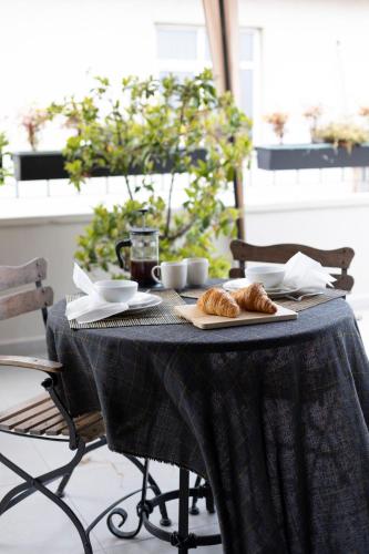 a table with croissants and cups on it at GALATA M84 in Istanbul