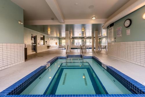 a swimming pool in a large room with a large at Holiday Inn Express Golden-Kicking Horse, an IHG Hotel in Golden