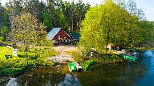 an aerial view of a house and a lake with a boat at Stanica Wodna Płaska in Płaska
