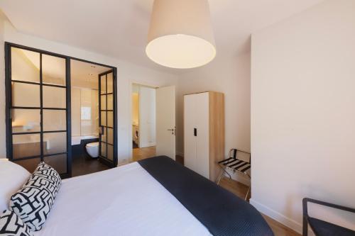 a bedroom with a large white bed and a mirror at GALATA M84 in Istanbul