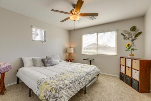 a bedroom with a bed and a ceiling fan at Spacious Avondale Home with Patio and Pool Access! in Avondale
