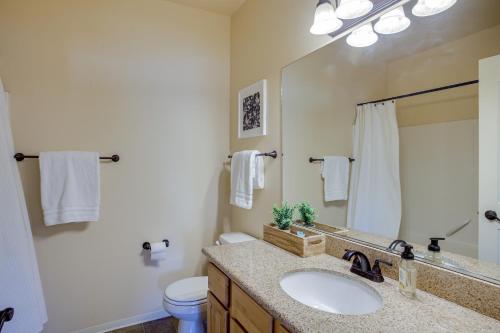 a bathroom with a sink and a toilet and a mirror at Coeur dAlene Vacation Rental 4 Mi to Hayden Lake in Coeur d'Alene
