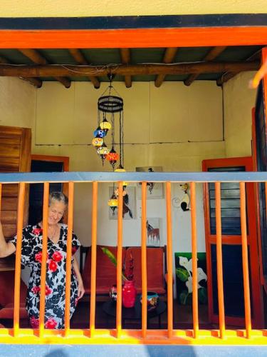 a woman standing behind the bars of a toy crib at RanchoVista coffee ring The land of Encanto in Quimbaya