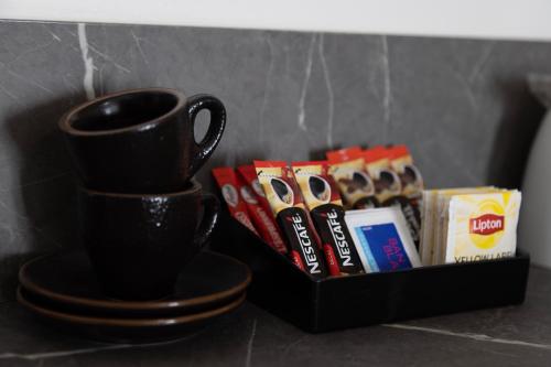 a black coffee cup and a tray of snacks at Bairnsdale International in Bairnsdale