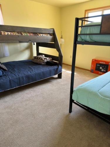 a bedroom with two bunk beds in a room at Sportsman Lodge Melrose MT in Melrose