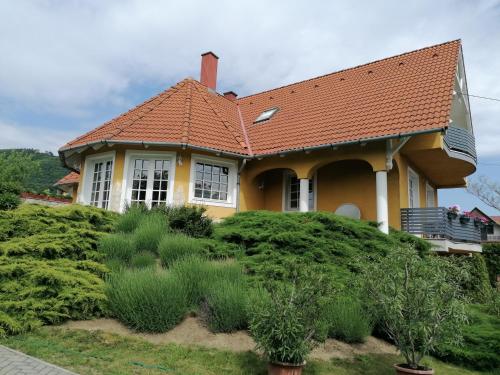 a yellow house with an orange roof at Vár-Lak Resort in Balatonederics