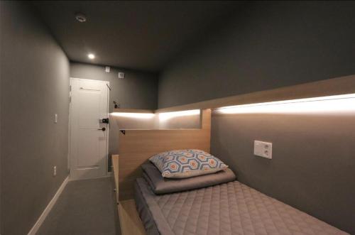 a small bedroom with a small bed in a room at Blueboat Hostel Jeonju in Jeonju