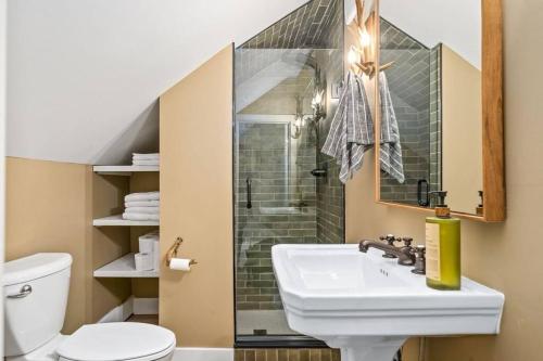 a bathroom with a sink and a shower and a toilet at Urban Cabin - Downtown Picton in Picton