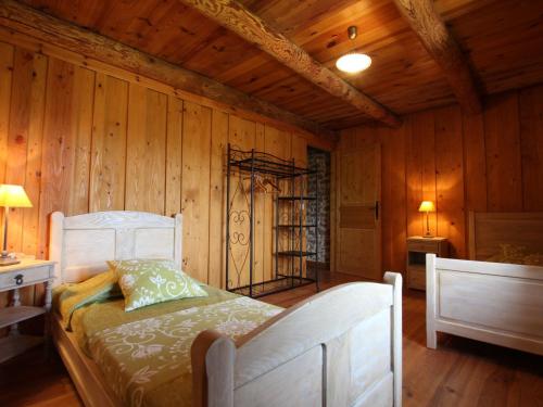 una camera con un letto in una stanza con pareti in legno di Gîte Aurec-sur-Loire, 4 pièces, 6 personnes - FR-1-582-191 a Aurec-sur-Loire