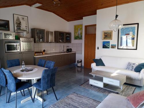 a kitchen and living room with a table and a couch at Guesthouse Gradina in Lovište