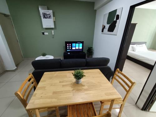 a living room with a wooden table and a couch at Pacific Place Ara Damansara LRT Pool Parking Kitchen By Kenangan Homes in Petaling Jaya