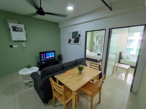 a living room with a table and a couch at Pacific Place Ara Damansara LRT Pool Parking Kitchen By Kenangan Homes in Petaling Jaya