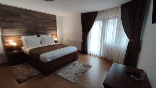 a hotel room with a bed and a table at Pensiunea Antonio Bran in Bran