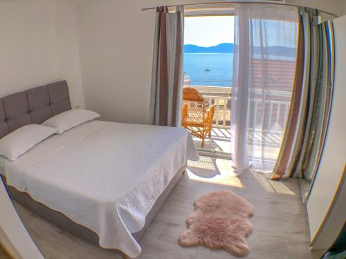 a bedroom with a bed and a view of the ocean at Apartments by the sea Gradac, Makarska - 13181 in Gradac