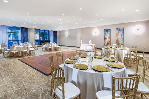 a banquet hall with white tables and chairs at Crowne Plaza Hotel Los Angeles Harbor by IHG in San Pedro